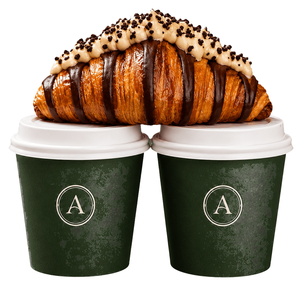 Chocolate-topped croissant on Artisan coffee cups